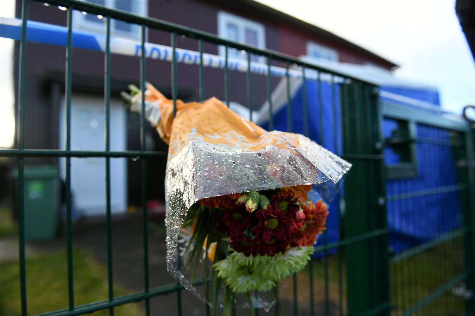 Flowers have been left outside the house where Inverness dad Ross MacGillivray was murdered.